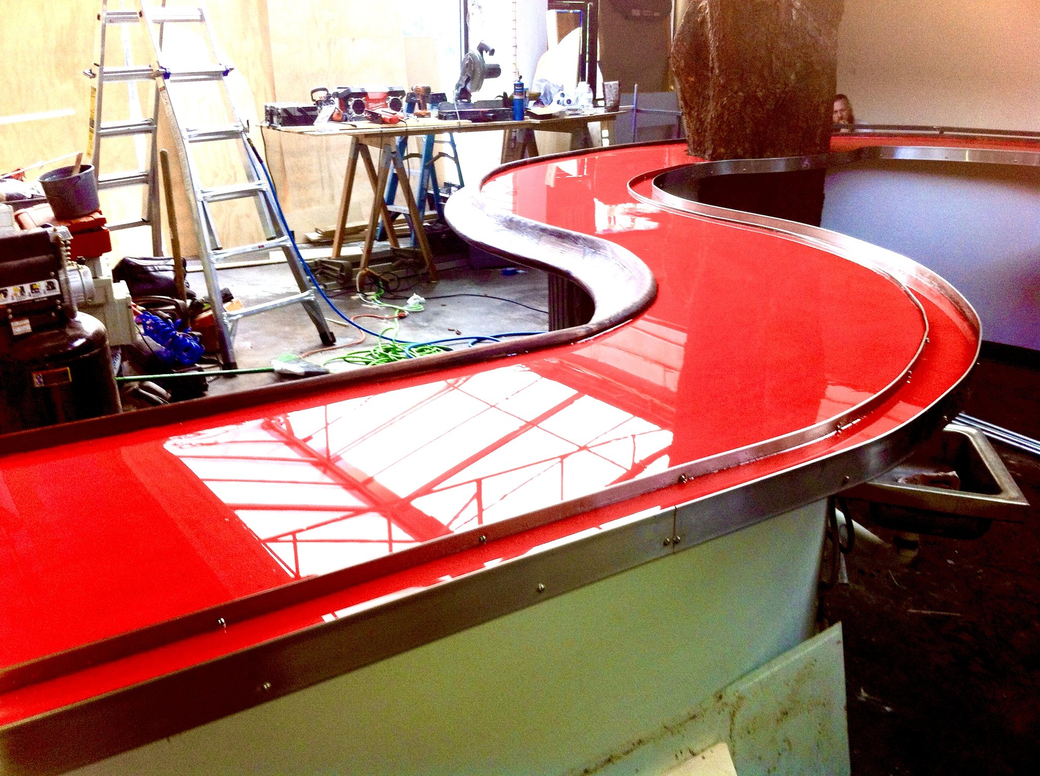 Curved red epoxy bar top — commercial bar fabrication