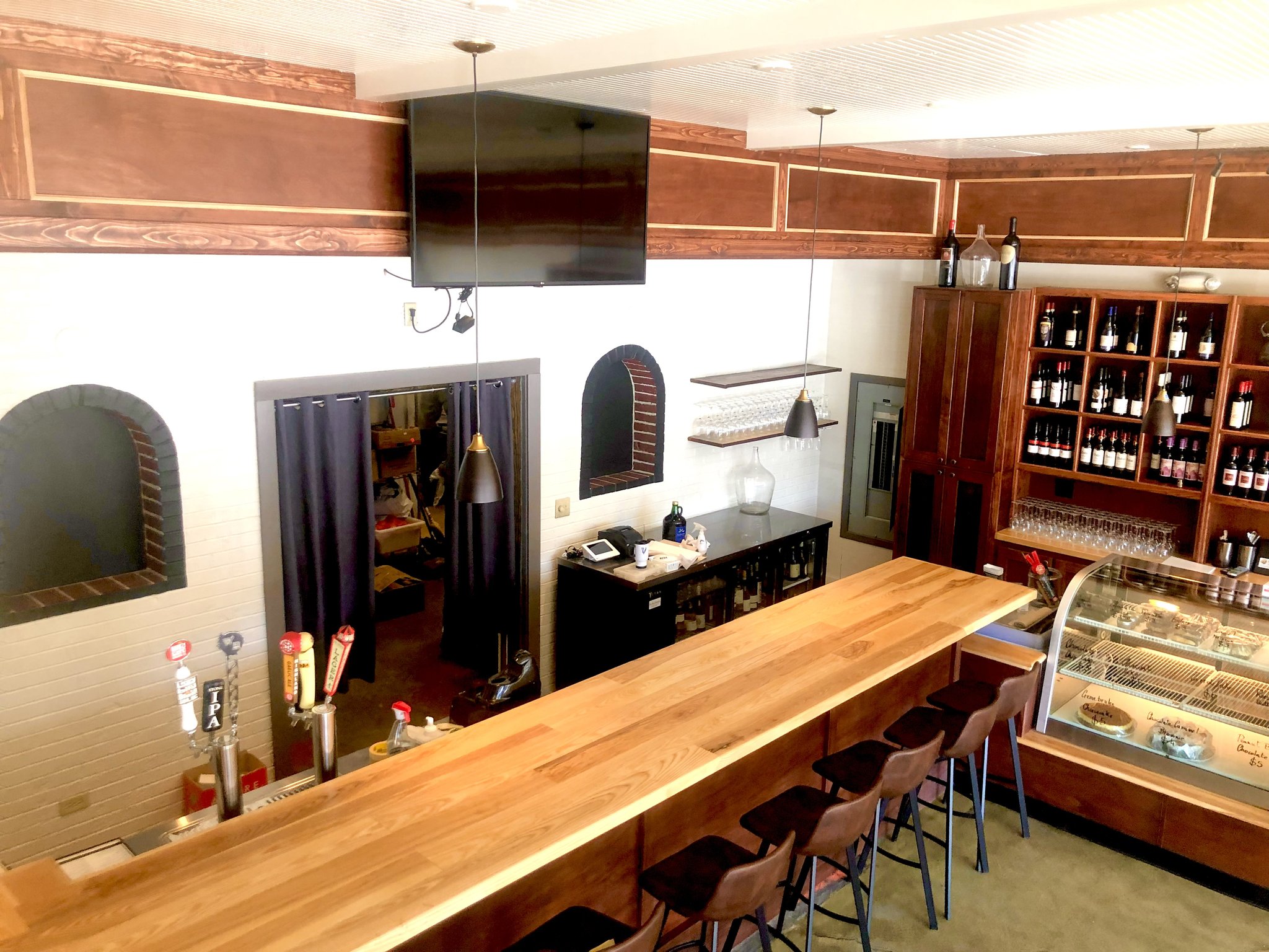 Long hardwood bar top and wine display millwork at Asheville restaurant