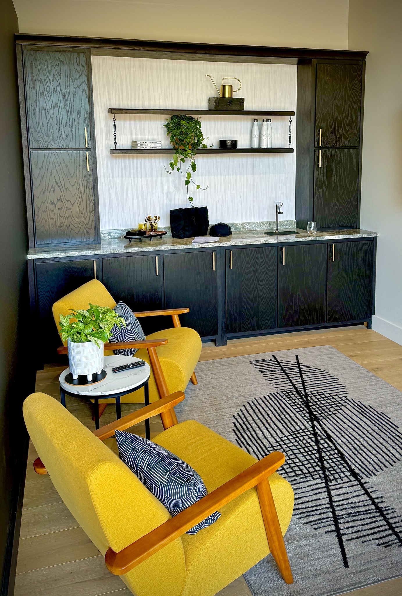 Custom ebony-finish cabinetry and open shelving at Unique Real Estate Collective, Asheville NC