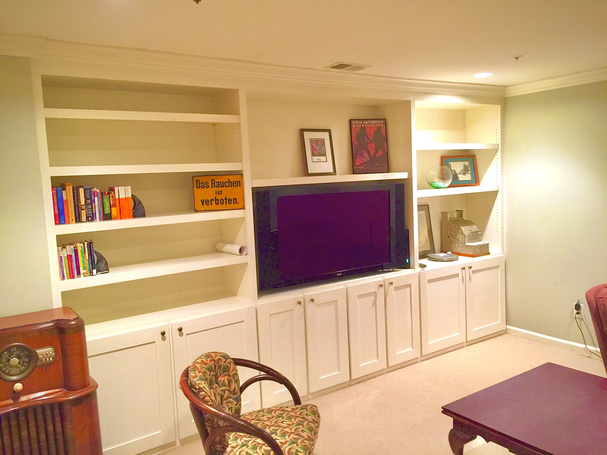 Painted residential built-ins as media center wall with crown molding